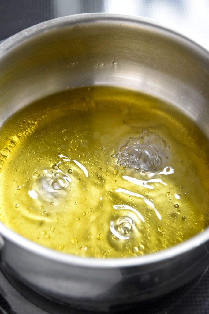 oil and water bubbling in a sauce pan.
