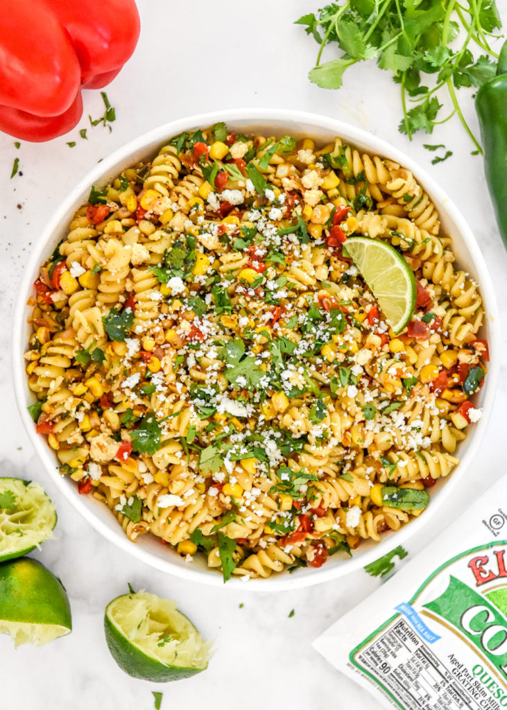 pan roasted corn pasta salad with lime in a serving bowl.