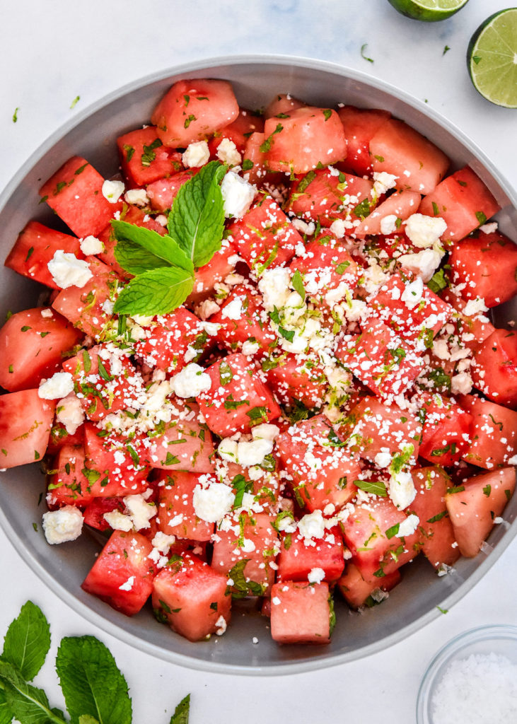 Watermelon Feta Mint Salad in a shallow serving bowl with mint leaves on top. 