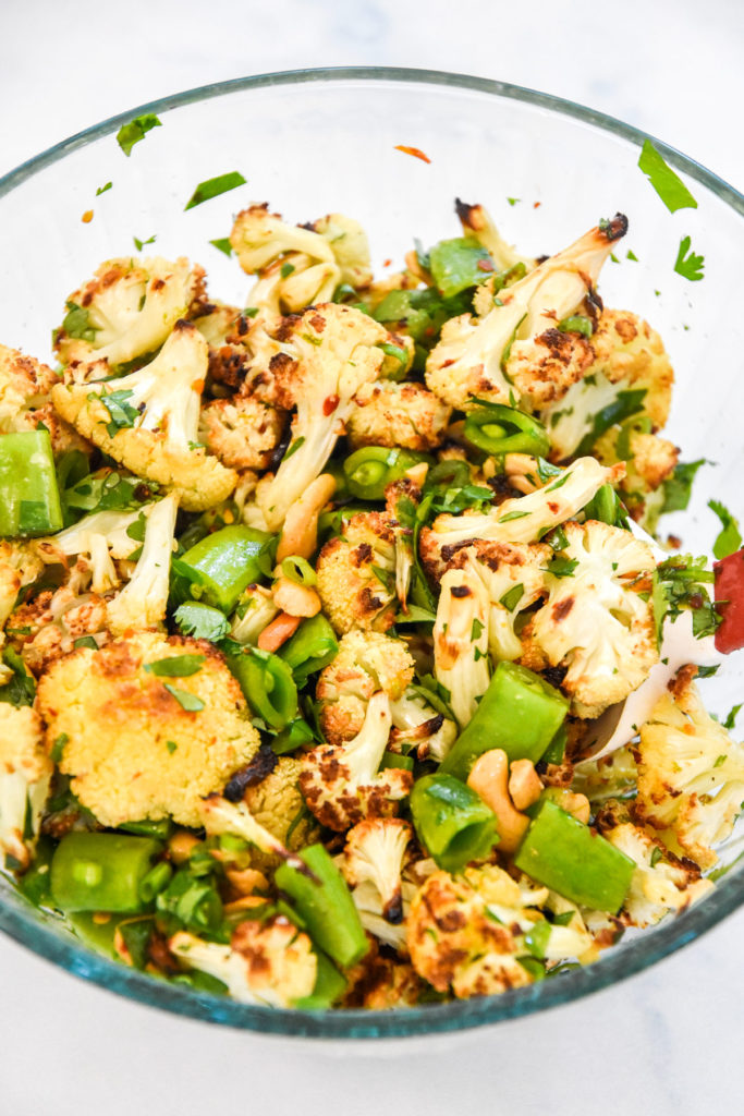 chili lime roasted cauliflower salad in a glass bowl.